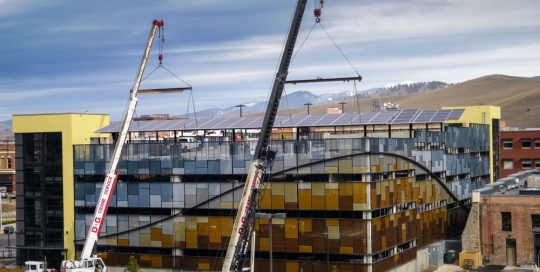 installation with cranes of 85 kilowatt solar array in missoula montana parking structure